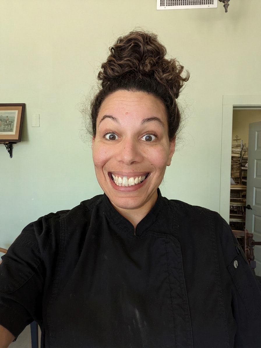Shala, baker and founder of Shoobies Baking, smiling in her chef coat